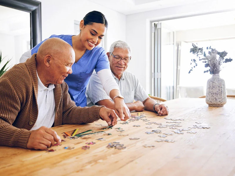Elderly partners collaborating on a jigsaw puzzle